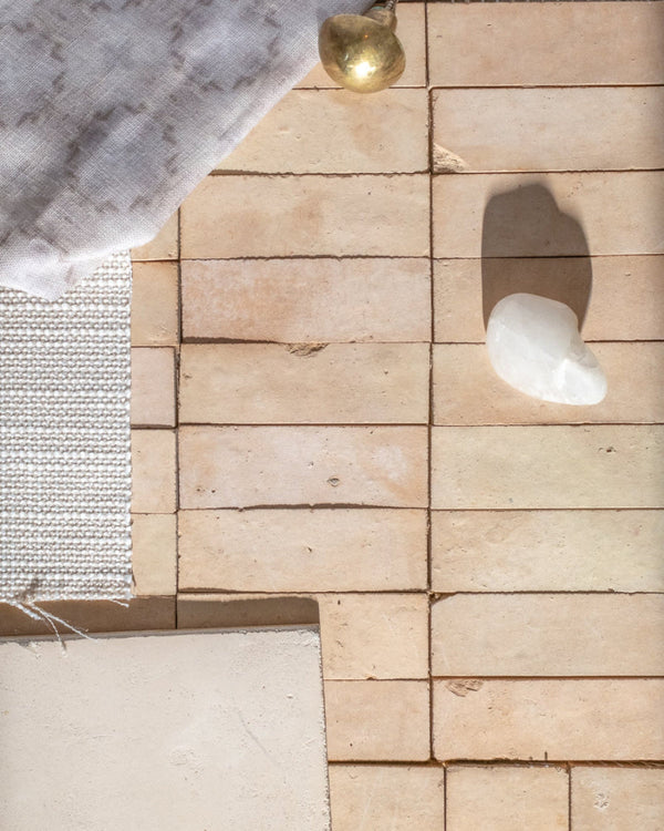Unglazed Zellige tile with fabric, stone and hardware samples.