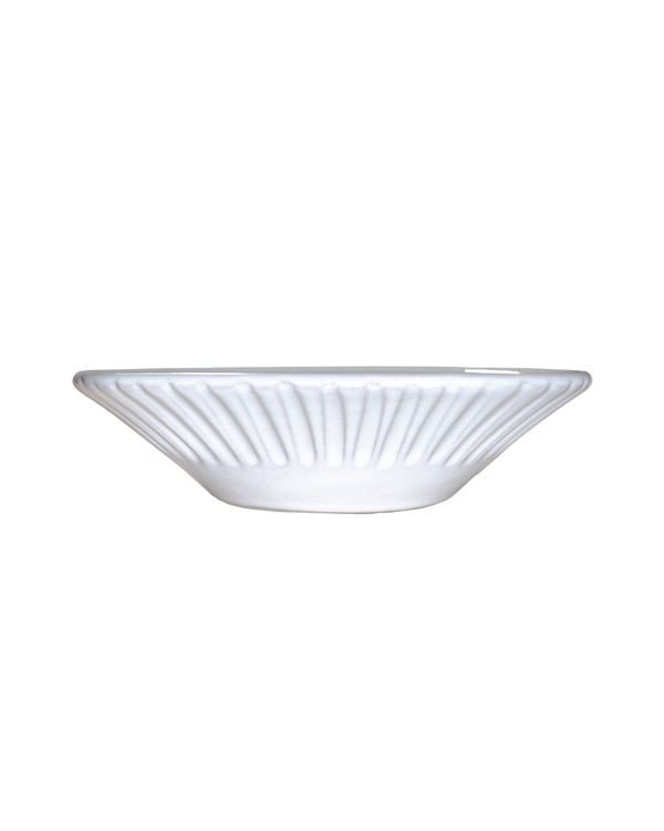 White ceramic bowl with ribbed design on a white background