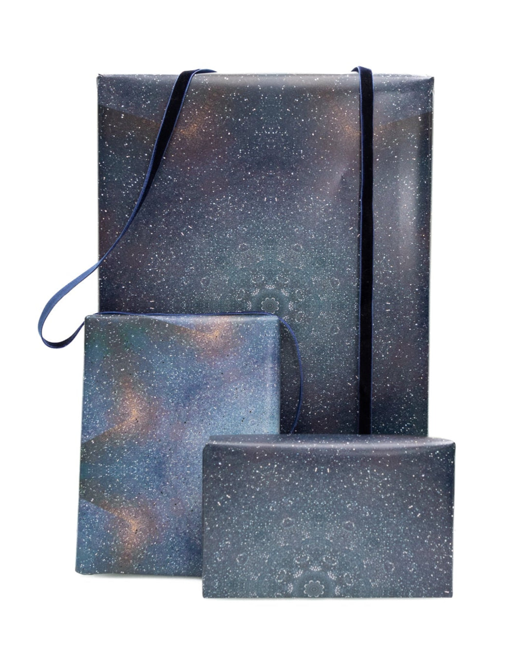 Set of three dark blue gift boxes with metallic accents on a white background